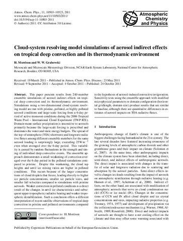 Cloud-system resolving model simulations of aerosol indirect effects on tropical deep convection and its thermodynamic environment